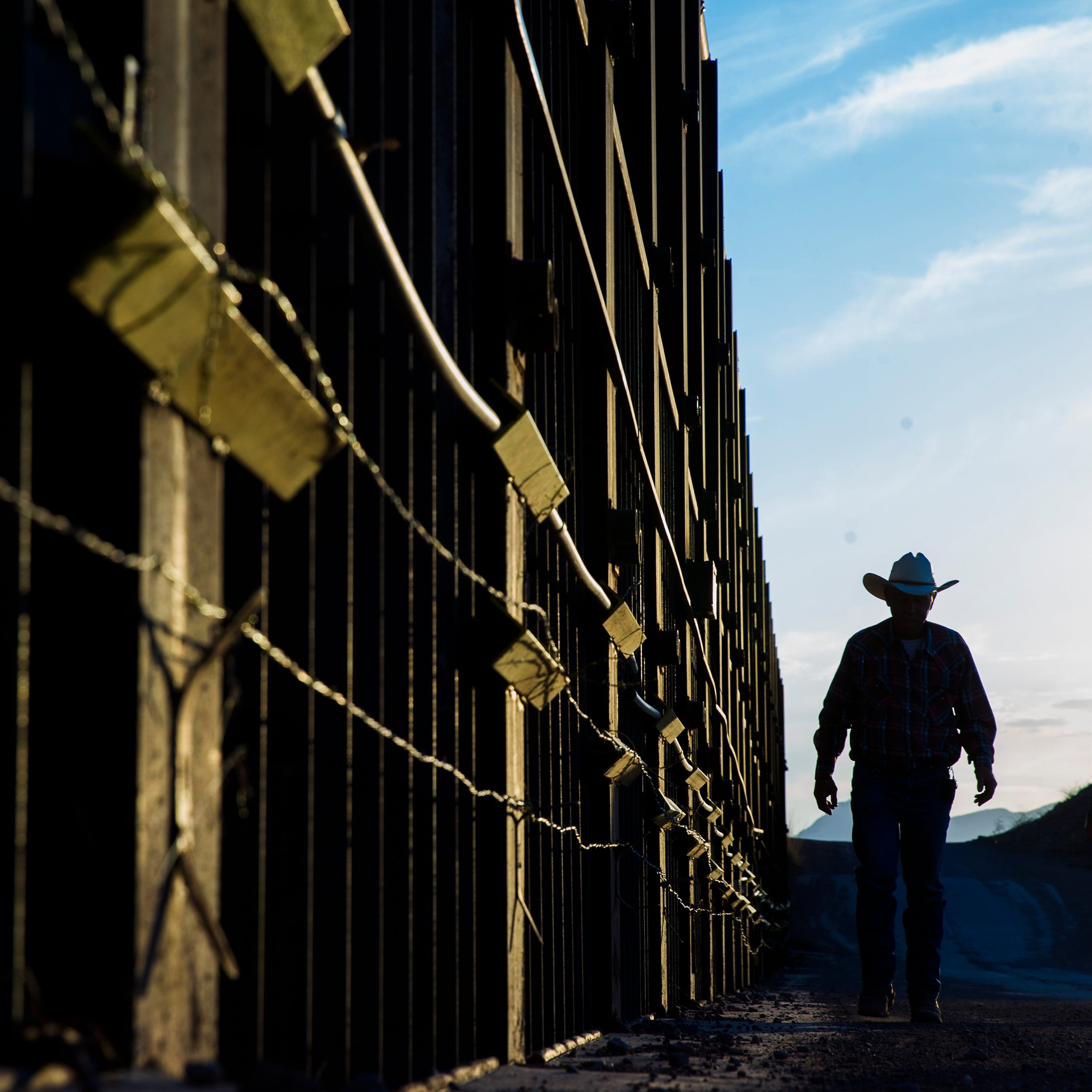 Rancher John Ladd walks along the fence on his ranch, which borders with Mexico. He has been frustrated for years over the illegal border crossers and drug smugglers who cut through his ranch. The 16,000-acre operation has been in the Ladd family for