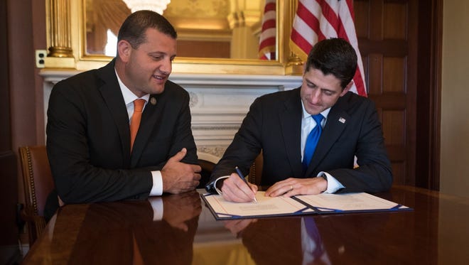 House Speaker Paul Ryan, right, signs the Social Security Number Fraud Prevention Act Congressman david Valadao (R-Hanford) introduced in January. The proposed legislation now awaits President Trump's signature.