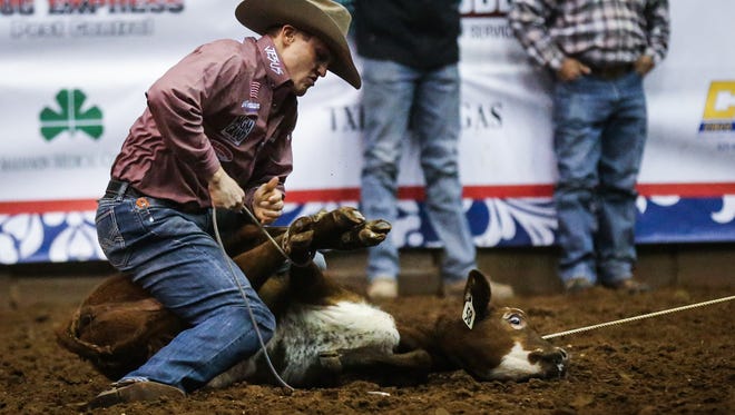 Tuf Cooper ties down a calf during the 6th performance of the San Angelo Stock Show and Rodeo Saturday, Feb. 10, 2018, at Foster Communications Coliseum.