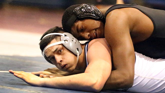 Shawn Boutte, top, of Buena High School in Sierra Vista, Ariz., wrestles with Andres Perez of Del Valle in the boys 182-pound championship match Saturday at the Bowie Wrestling Tournament. Boutte won.