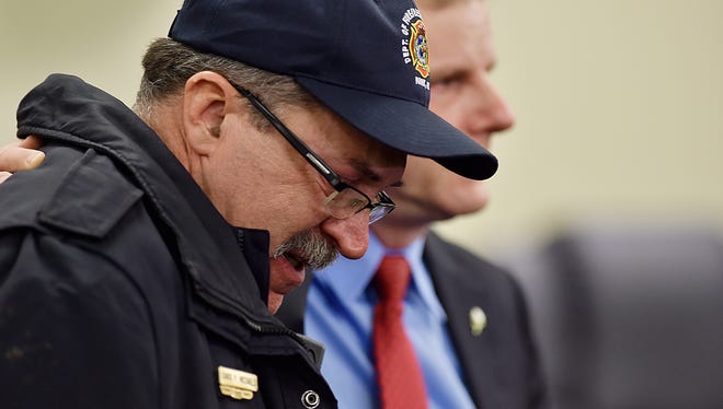 York City Fire Chief David Michaels retreats from the podium next to York Mayor Michael Helfrich after speaking at a press conference Thursday, March 22, 2018, at city hall in York. York Mayor Michael Helfrich confirmed that two firefighters, Ivan Flanscha and Zachary Anthony, died and that two others, assistant chief Greg Altland and firefighter Erik Swanson, are recovering from their injuries.