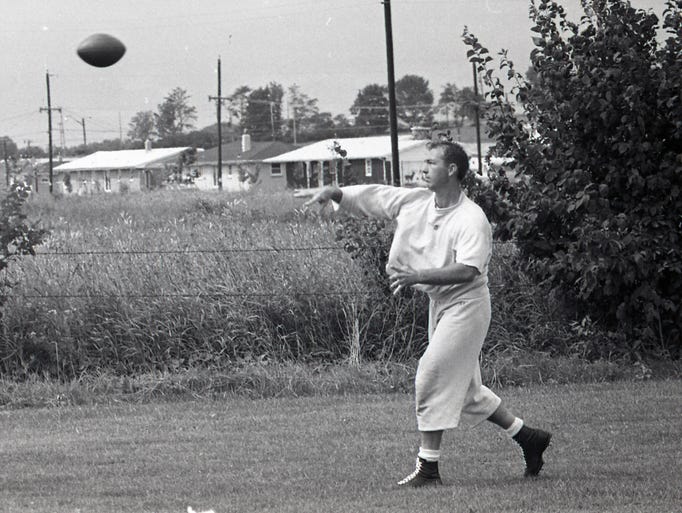 Green Bay Packers quarterback Bart Starr throws a pass as training camp begins on the team's practice field across the street from new City Stadium in mid-July 1962.
