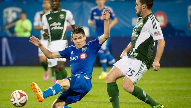 Montreal Impact's Maxim Tissot tries to block the pass of Portland Timbers' Danny O'Rourke during second half MLS action in Montreal on Sunday, July 27, 2014. (AP Photo/The Canadian Press, Peter McCabe)