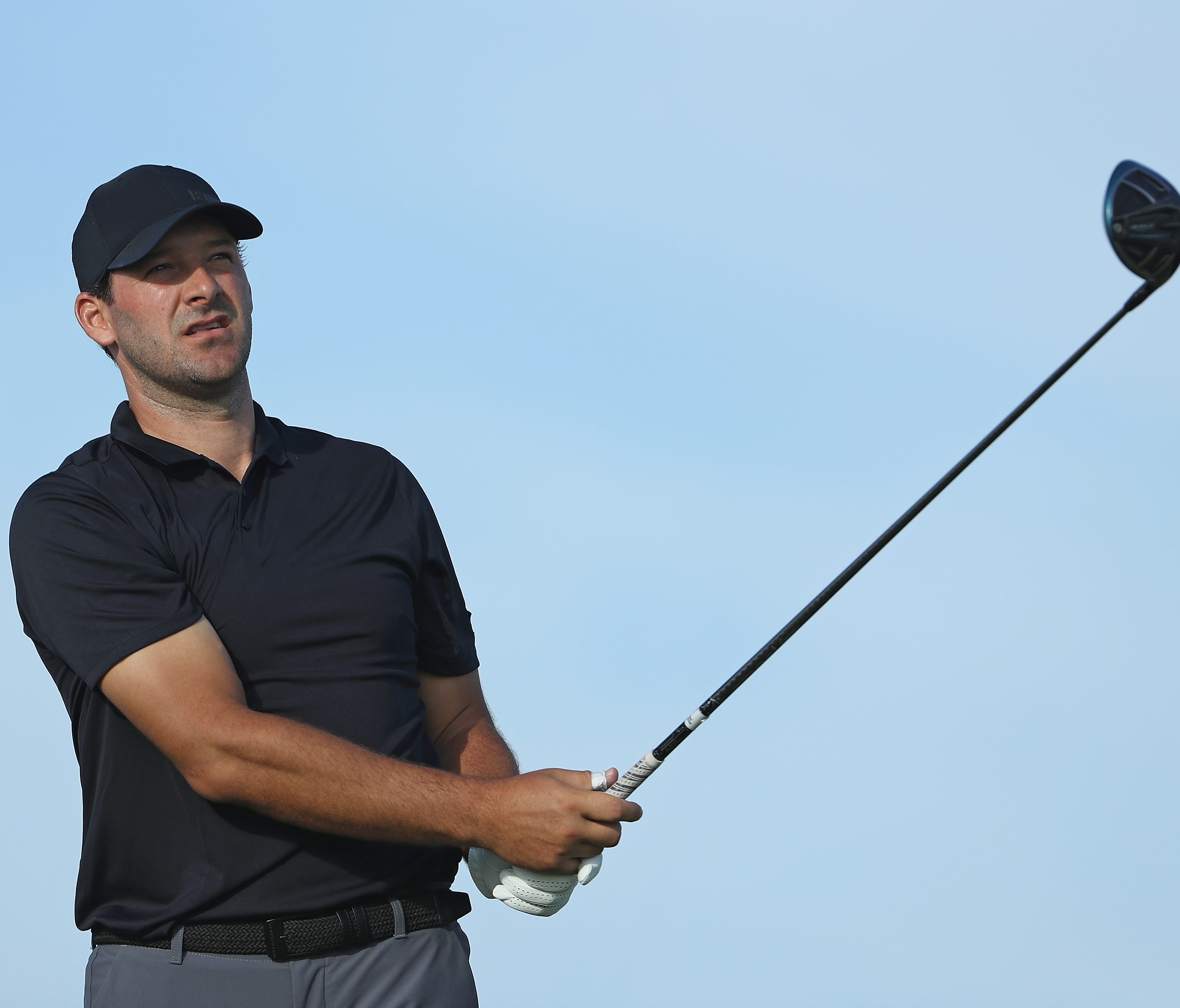 In a fie photo from March, former NFL quarterback Tony Romo plays his shot from the first tee during round one of the Corales Puntacana Resort & Club Championship in Punta Cana, Dominican Republic.