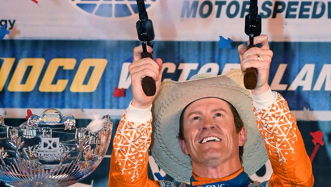Scott Dixon, of New Zealand, shoots blank in Victory Lane after winning the IndyCar auto race Saturday, June 9, 2018, in Fort Worth, Texas. (AP Photo/Larry Papke)