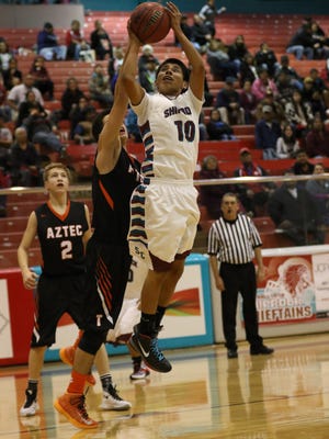 Shiprock's Keion Harvey goes around Aztec's Canyon Goimerac on Thursday
in the second half of a Jerry Richardson Memorial Tournament game in Shiprock.