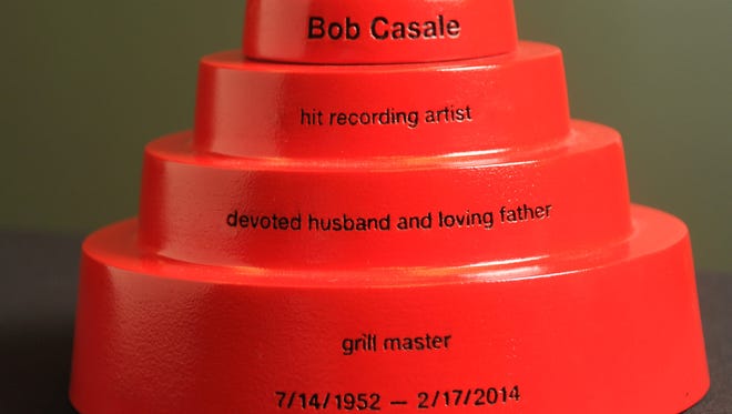A composite ceramic custom printed 3-D funeral urn made by Foreverence for Devo co-founder Bob Casale, depicting the hats worn by the band Devo, is seen in Eden Prairie, Minn., on Oct. 23, 2014.