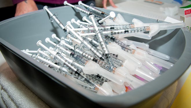 A tray holds syringes filled with adult-dosage flu vaccine at Memorial Medical Center's yearly Drive-Thru Flu Clinic on Saturday.