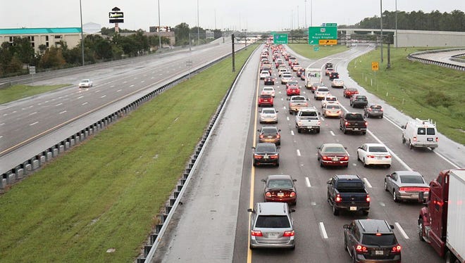 People drive out of the Orlando area in Kissimmee, Florida in preparation for the landfall of Hurricane Matthew, on October 6, 2016. 
Some three million people on the US southeast coast faced an urgent evacuation order Thursday as monstrous Hurricane Matthew -- now blamed for more than 100 deaths in Haiti alone -- bore down for a direct hit on Florida.
 / AFP / Gregg Newton        (Photo credit should read GREGG NEWTON/AFP/Getty Images)