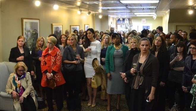 People gather for the opening party organized for Dress for Success Rochester, which opened downtown at 47 State St.