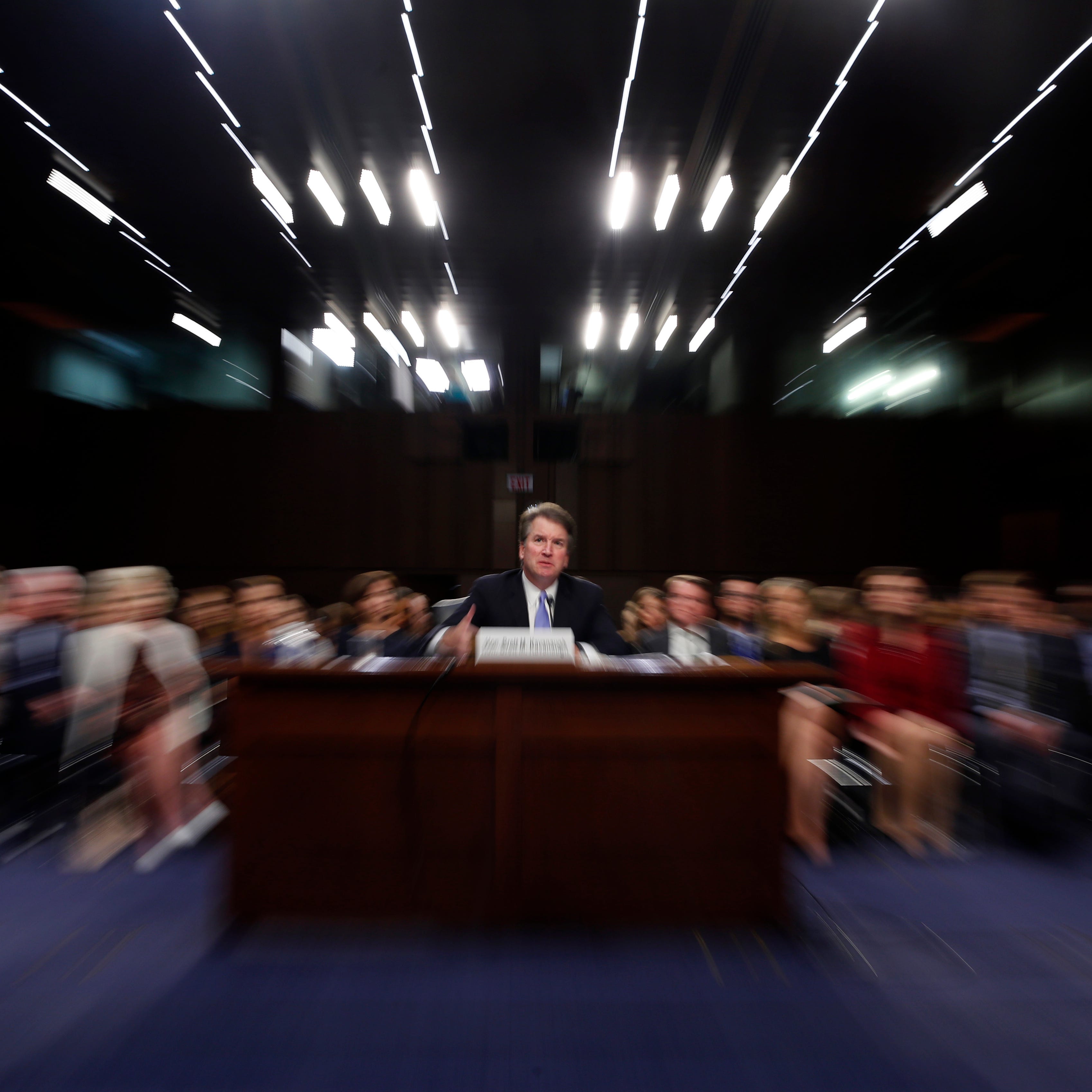 In this photo taken with a slow shutter speed and a zoom, President Donald Trump's Supreme Court nominee, Brett Kavanaugh testifies before the Senate Judiciary Committee on Capitol Hill in Washington, Thursday, Sept. 6, 2018, for the third day of his