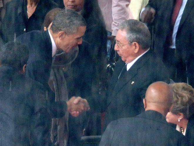 
U.S. President Barack Obama (L) shakes hands with Cuban President Raul Castro during the official memorial service for former South African President Nelson Mandela at FNB Stadium December 10, 2013 in Johannesburg, South Africa.
