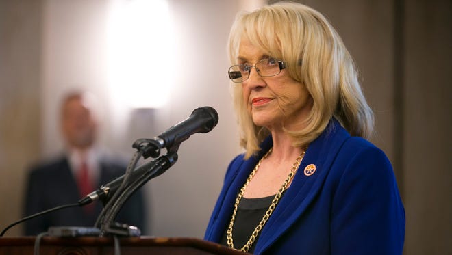 Gov. Jan Brewer speaks during a press briefing on the plan to create a new child-welfare agency in the executive tower at the Arizona state capitol in Phoenix on Thursday, May 22, 2014.