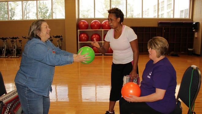 Sharon Benn, left, learns the basics of chair aerobics at the Selma YMCA in an effort to exchange her couch potato status for one leading to physical fitness. Helping her Friday were Gail Blake, center, and Stacy Buchanan. (Alvin Benn/Special to the Advertiser)
