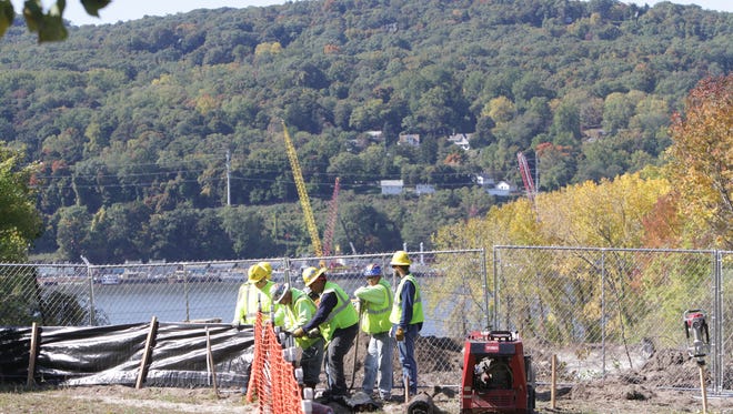 Workers are seen erecting a fence in Verplanck in 2015 as part of Spectra Energy's Algonquin natural gas pipeline expansion. Tomkins Cove is visible across the Hudson River. The 42-inch diameter pipeline is being placed under the Hudson River from Tomkins Cove to Verplanck in Westchester and will eventually stretch through Connecticut, Rhode Island and Massachusetts.