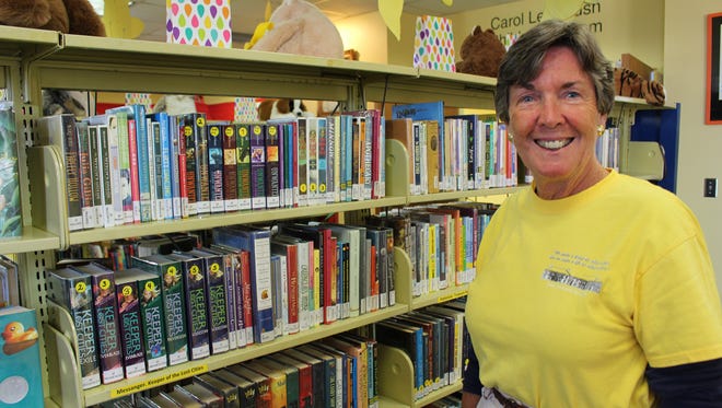 Selma-Dallas County Librarian Becky Nichols  is surrounded by just a few of the books on display at the Children’s section of the huge facility. Alvin Benn/Special to the Advertiser