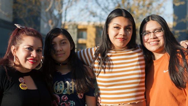 In this Dec. 22, 2017, photo, Ericka Lopez, from left, and her daughters Emily Garcia, 12, Anna Ramos Lopez, 16, and Glenda Ramos Lopez, 20, stand in front of their home in Las Vegas. Lopez, from El Salvador, fears her family will be split in half because some are citizens and some are under Temporary Protected Status.