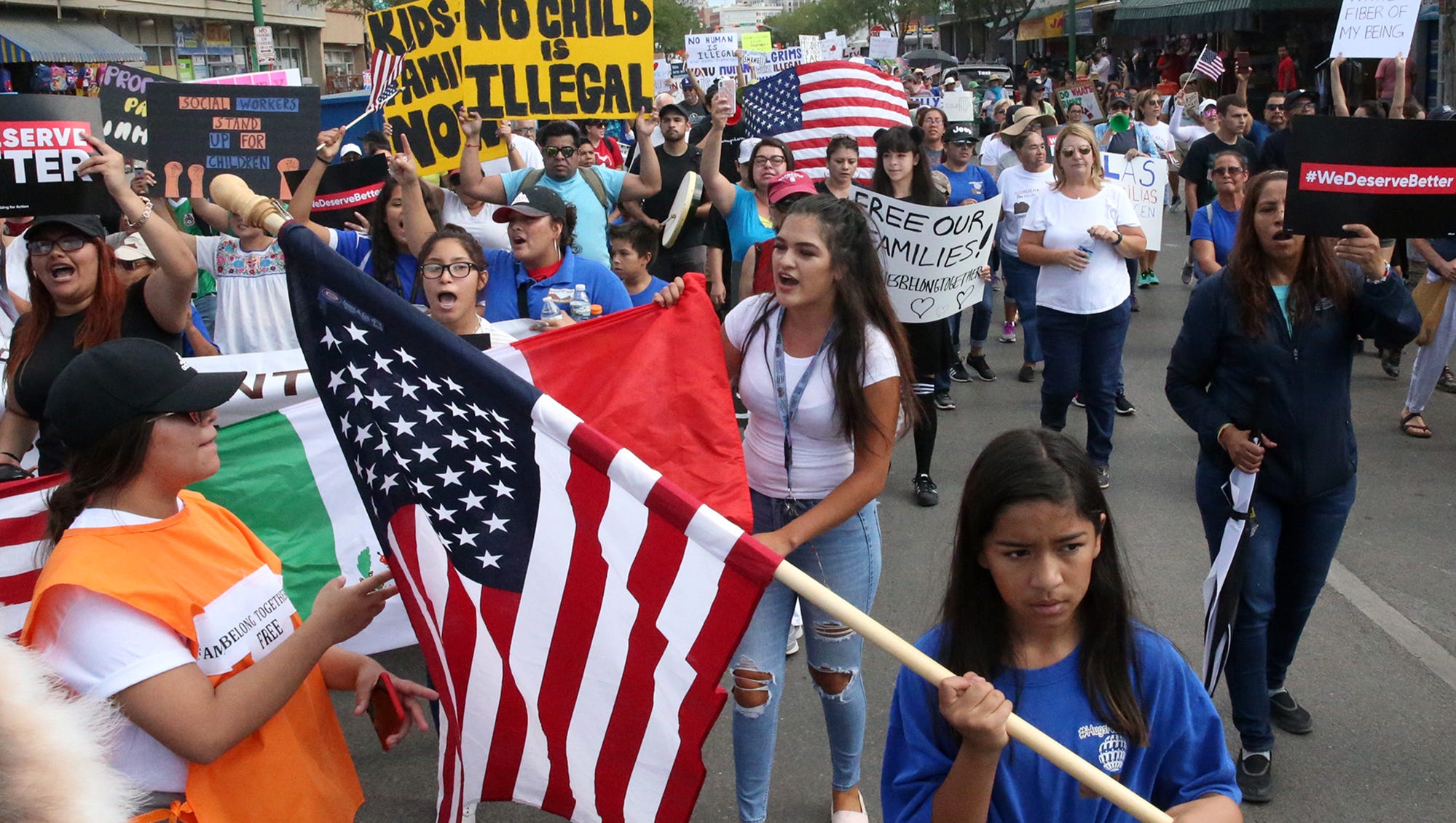 Demonstrators march down South El Paso Street to the