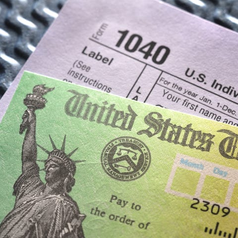 Tax Form 1040 and a refund check
