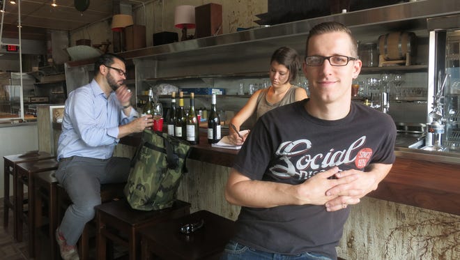Chef-owner James Rigato pauses at the bar of his new Hazel Park restaurant, Mabel Gray, while sommelier Rachel Van Til meets with Antoine Przekop of Little Man Wine & Spirits.