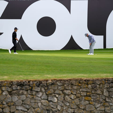 Kevin Na of the United States, left, stands on the
