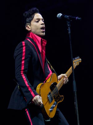 FILE - In this Nov. 14, 2010 file photo, musician Prince performs in Yas Island, on the final night of the F1 motor race meeting in Abu Dhabi, United Arab Emirates. Prince's publicist has confirmed that Prince died at his his home, Thursday, April 21, 2016. He was 57. (AP Photo/Nousha Salimi, File)