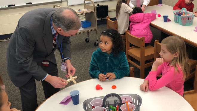 Sen. John Eichelberger Jr. (left) works with second-graders Saniyah Henderson (middle) and Lillie Mason (right) on building a catapult during a STEM lesson the morning of Monday, March 5 at Hamilton Heights Elementary School in Chambersburg.
