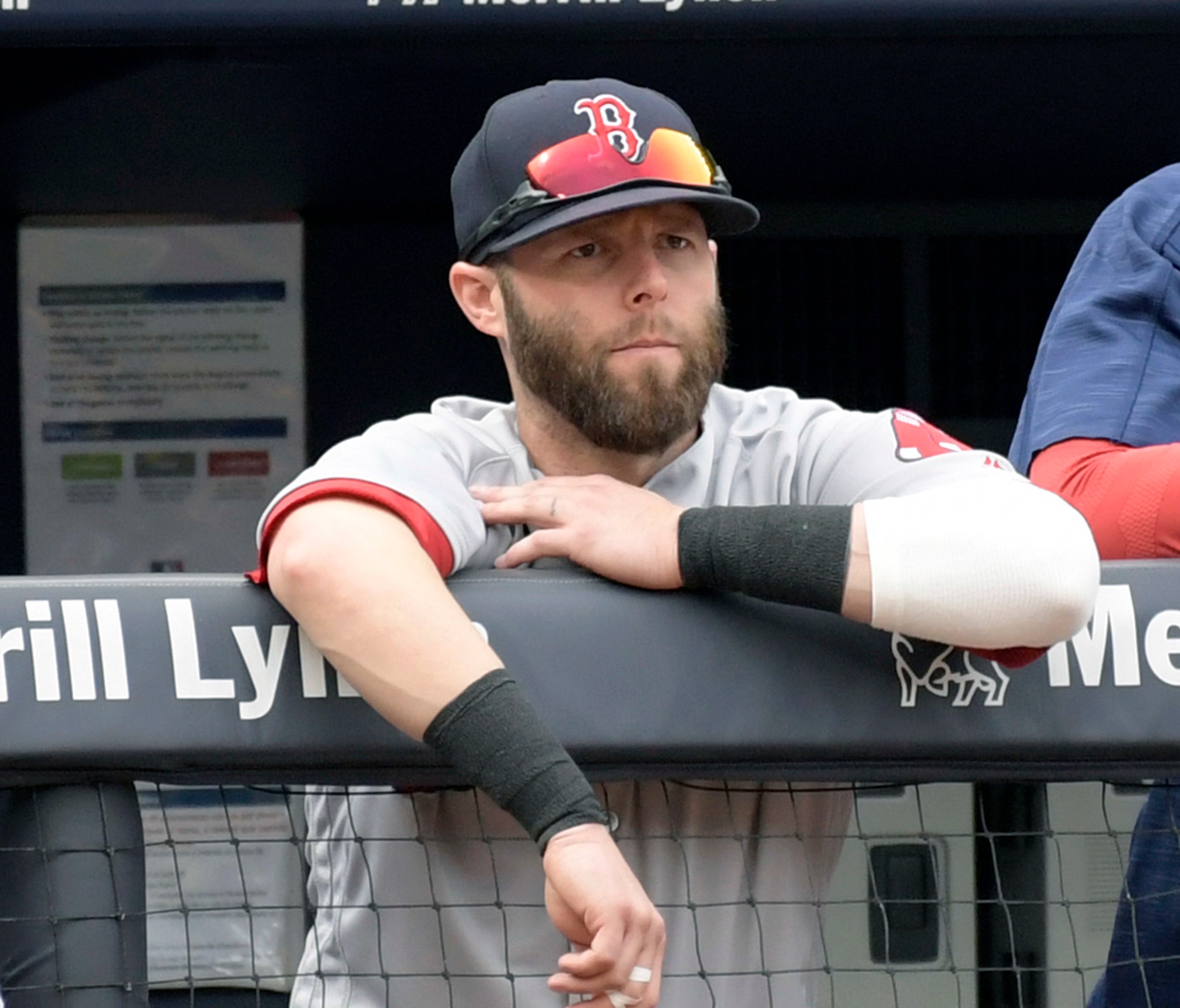 Red Sox second baseman Dustin Pedroia looks on from the dugout.
