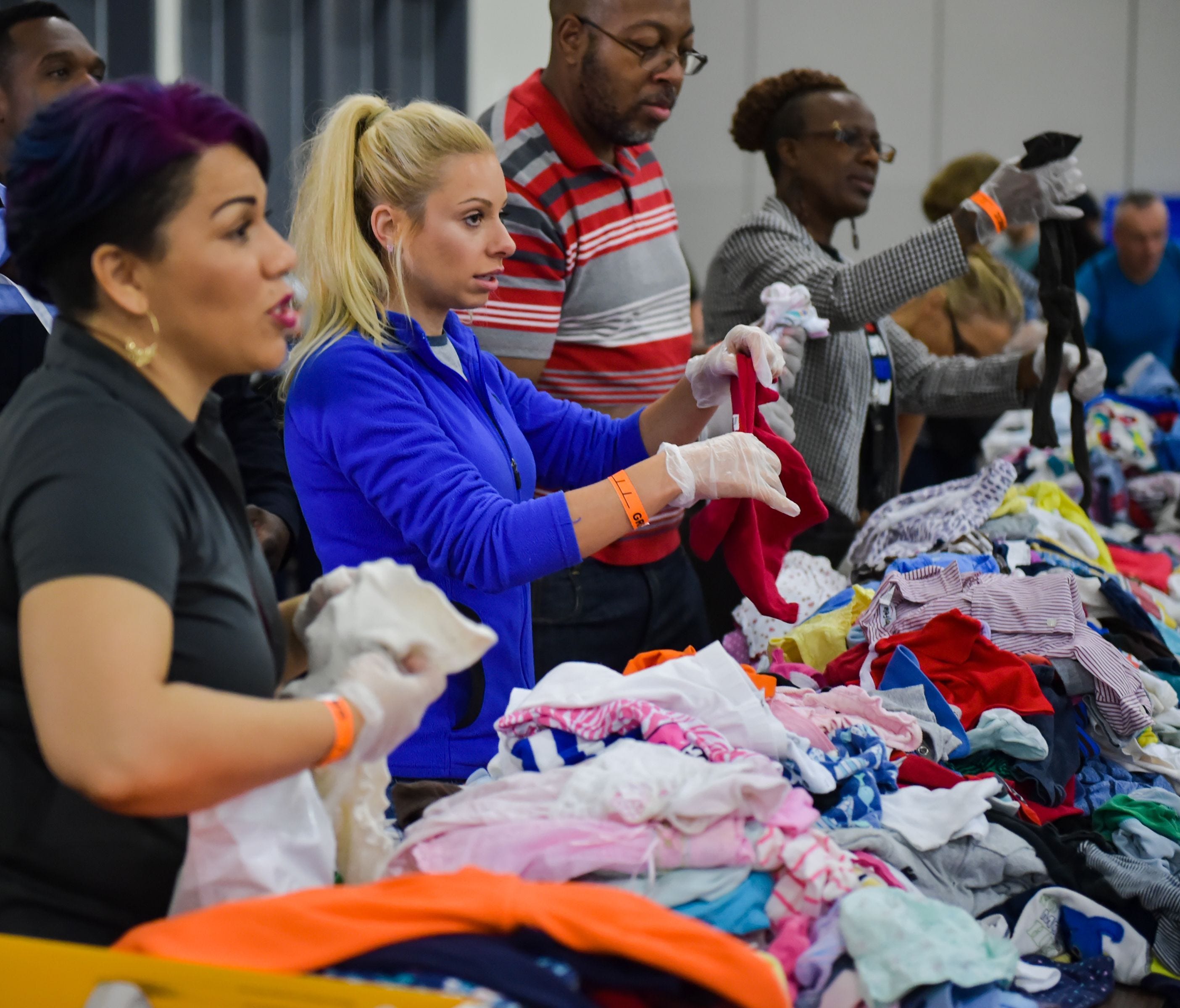 Volunteers Elizabeth Duran and Dana Jamieson helping to sort clothes at the George R. Brown Convention Center in Lafayette, La.  which is being used as a shelter for residents who have been displaced by flood waters on Aug. 28, 2017.