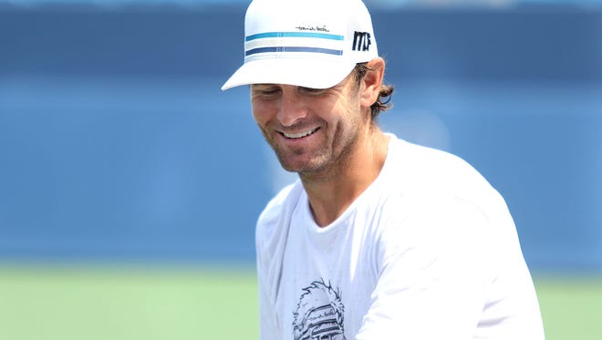Mardy Fish takes a break from practicing with Steve Johnson on Center Court before the start of the Western and Southern Open at the Lindner Family Tennis Center in Mason. This is one of two final tournaments Fish will play before retirement.