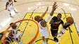 Kyrie Irving goes for a layup over David West during