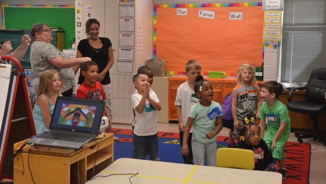 Kindergarten Success Program students and classroom helpers get excited during a lesson Wednesday.