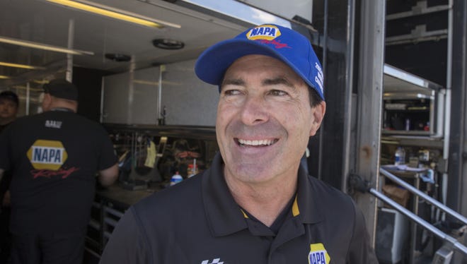 Ron Capps, a funny car racer, talks with a reporter during a practice day at Lucas Oil Raceway, in advance of the Labor Day weekend NHRA event, Indianapolis, August 23, 2017.