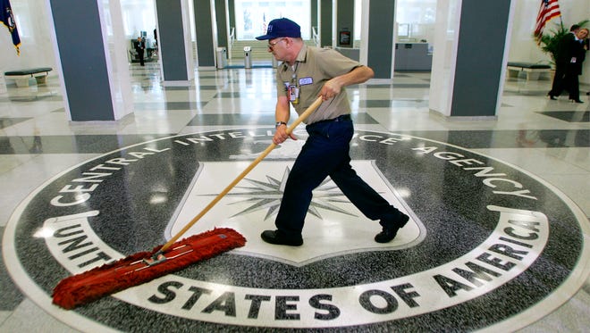 FILE - In this March 3, 2005 file photo, a workman slides a dustmop over the floor at the Central Intelligence Agency headquarters in Langley, Va. Senate investigators have delivered a damning indictment of CIA interrogation practices after the 9/11 attacks, accusing the agency of inflicting pain and suffering on prisoners with tactics that went well beyond legal limits. The torture report released Tuesday by the Senate Intelligence Committee says the CIA deceived the nation with its insistence that the harsh interrogation tactics had saved lives. It says those claims are unsubstantiated by the CIA's own records. (AP Photo/J. Scott Applewhite)