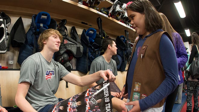 US national under-18 player Tyler Weiss greets a young fan before a game against the Central Illinois Flying Aces.