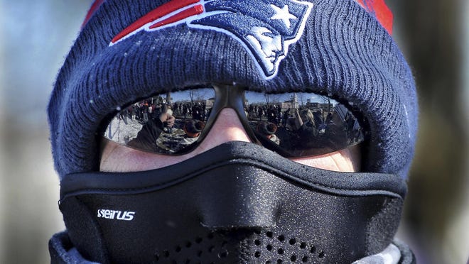 FILE A New England Patriots fan dresses for the biting cold during a town pep rally in Foxboro, Mass. Saturday, Feb. 4, 2017. Several hundred town residents showed up on the town common to show their support for their hometown team as they faced the Atlanta Falcons in Super Bowl LI. (Mark Stockwell/The Sun Chronicle via AP)