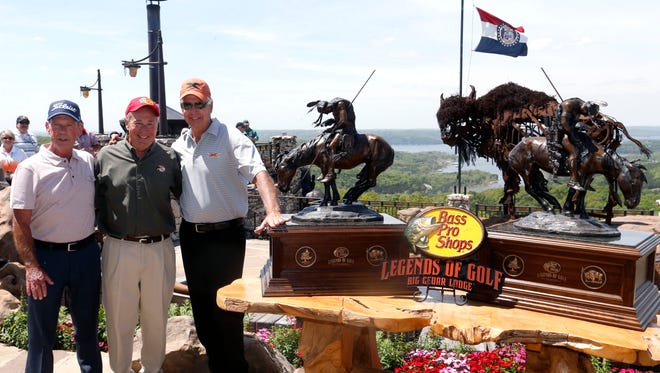 Golfers Larry Nelson (left) and Bruce Fleisher (right) stand with Bass Pro Shops founder Johnny Morris after they won the Legends division of the 2016 Bass Pro Shops Legends of Golf at Top of the Rock golf course in Ridgedale, Mo. on Sunday, April 24, 2016.