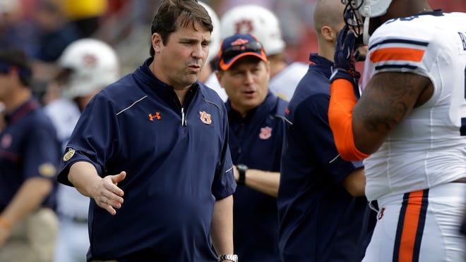 Newly-hired Auburn defensive coordinator Will Muschamp shakes hands with defensive lineman Angelo Blackson before the Outback Bowl on Thursday. Muschamp was the former head coach at Florida.