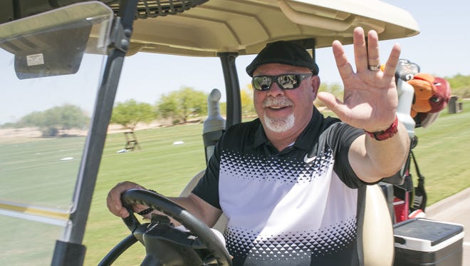 Bruce Arians waves as he heads out for a round of golf at the Arians Family Foundation Golf Classic at the Whirlwind Golf Club on Sat. Apr. 14, 2018 in Chandler, Ariz.