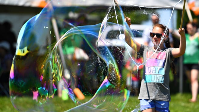 Lindsay Benswanger, 11, of New Windsor, Maryland, makes a giant bubble during the 18th Annual Penn-Mar Irish Festival at the Markets at Shrewsbury in Shrewsbury Township, Saturday, June 16, 2018. Dawn J. Sagert photo