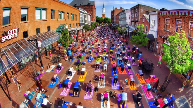 Yoga on Church Street 2014 as yoga practitioners fill the top block of the Marketplace.