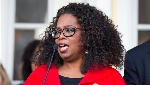 Oprah Winfrey address the crowd before she marches Edmund Pettus Bridge in honor of Martin Luther King Jr., Sunday, Jan. 18, 2015, in Selma, Ala. Winfrey joined some of the cast to promote the movie "Selma." (AP Photo/Brynn Anderson)