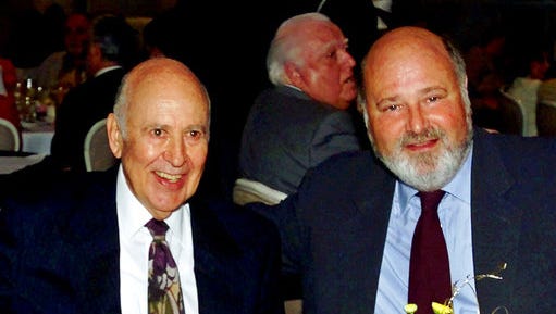FILE - In this Aug. 18, 2000 file photo, Carl Reiner, left, appears with his son Rob Reiner at a Friars Club of California dinner in his honor in Beverly Hills, Calif. The Reiners are set to make history at the TCL Chinese Theatre, becoming the first father and son to jointly leave their cement footprints outside the Hollywood landmark on April 7, 2017.