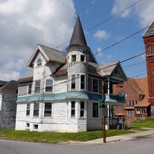 A house that is in foreclosure is seen July 14 in Amsterdam, N.Y. They are called “zombie homes, ” properties that are no longer under control of their owners with pending foreclosure, but not yet under control of a bank or lender. New York has an estimated 15,000 of them.
