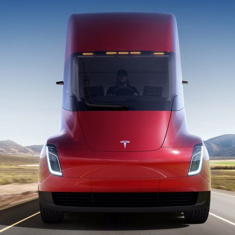Red semi tractor trailer truck with Tesla logo on 