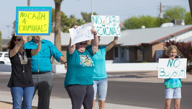 Scottsdale residents protest possible severance packages for Superintendent Denise Birdwell and Chief Operating Officer Louis Hartwell during a special Scottsdale school board meeting on April 6, 2018.