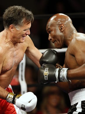 Mitt Romney and Evander Holyfield fight in a charity boxing event in Salt Lake City. The event was held to raise money for Charity Vision, a non-profit that aims to restore sight to the blind and visually impaired.
