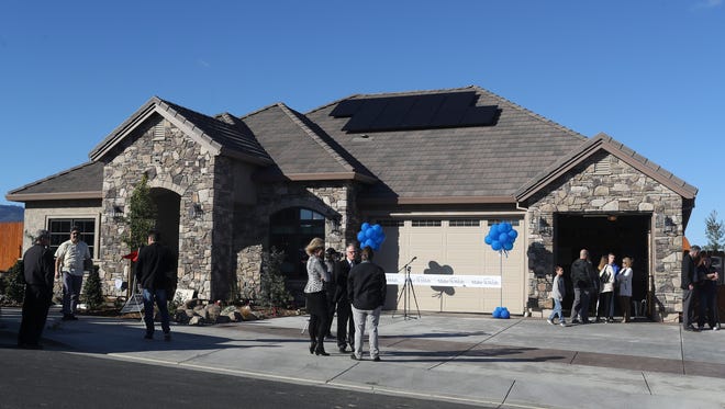 People get a look at the new home in Salt Creek Heights on Monday afternoon. The Palomar Builders home is part of a campaign to raise $100,000 for Make-A-Wish.