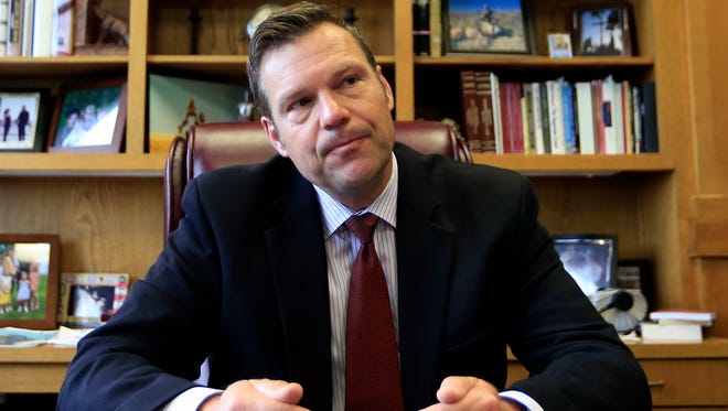 Kansas Secretary of State Kris Kobach, the vice chair of President Donald Trump's election fraud commission, talks with a reporter in his office in May.
