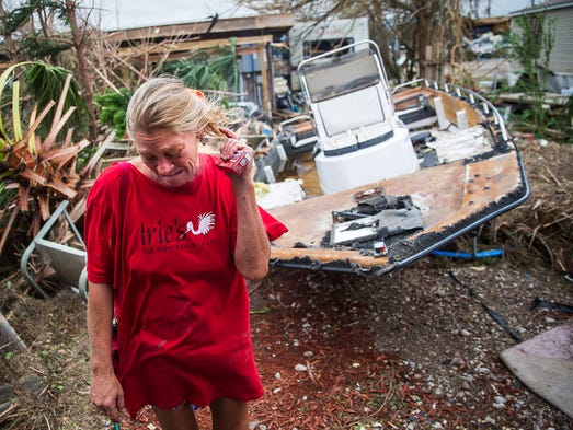 Emily Zurawski cries while inspecting her home in Port